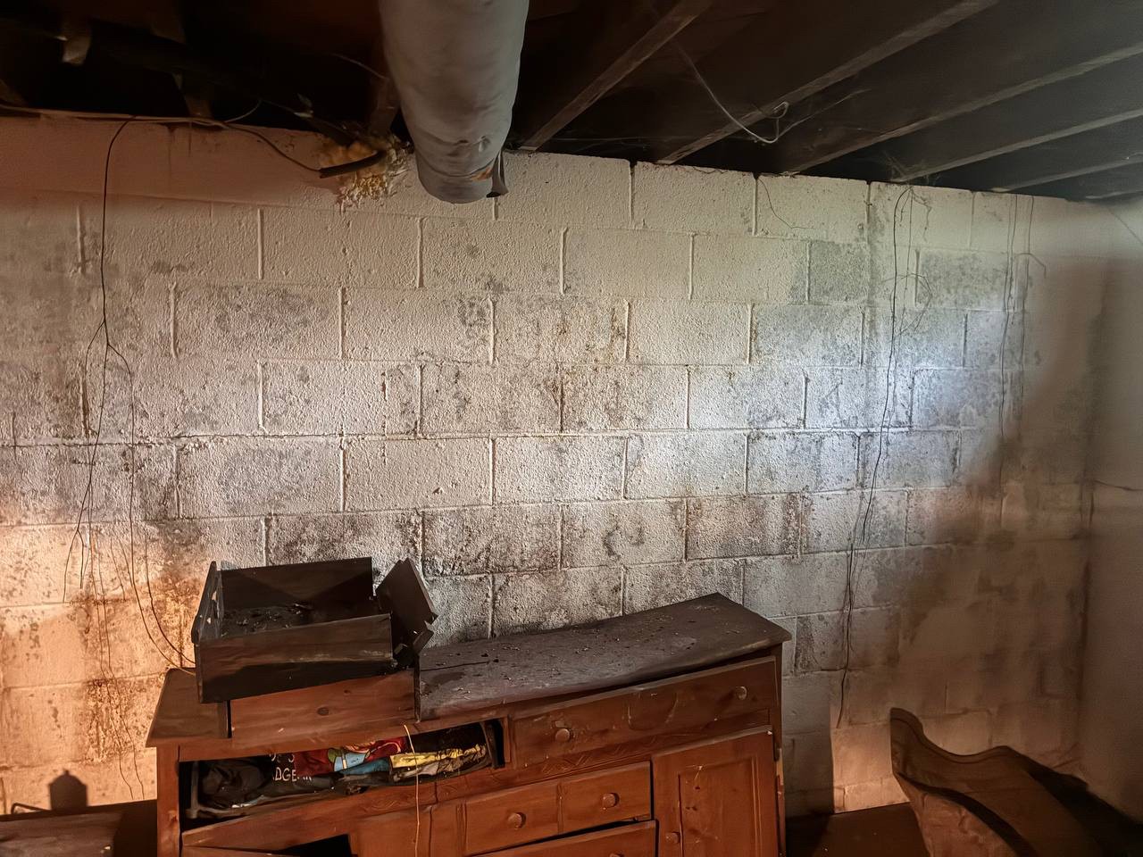 Moisture staining on the basement block wall